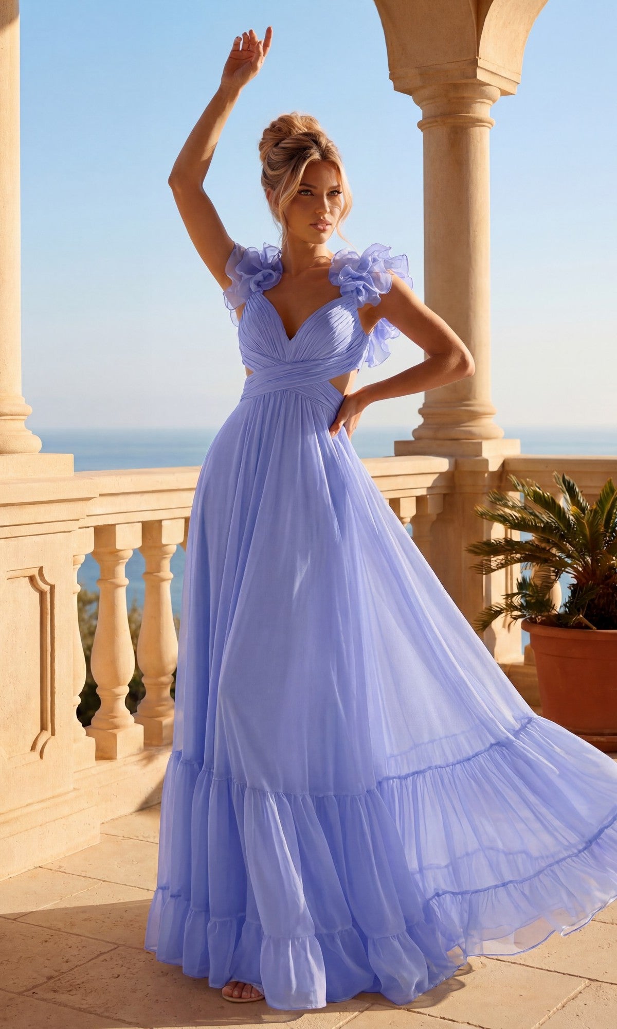 A woman in a periwinkle Long Prom Dress with Ruffle Straps: PromGirl Exclusive stands on a sunlit terrace with stone columns, holding up her hair and gazing into the distance, as a potted plant and blue sky create a tranquil scene.