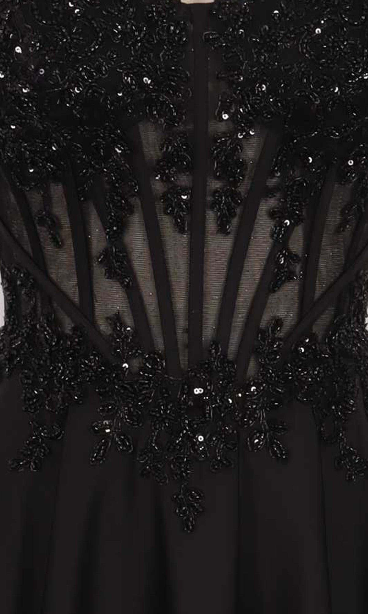 Close-up of a black dress with intricate beadwork and sheer panels