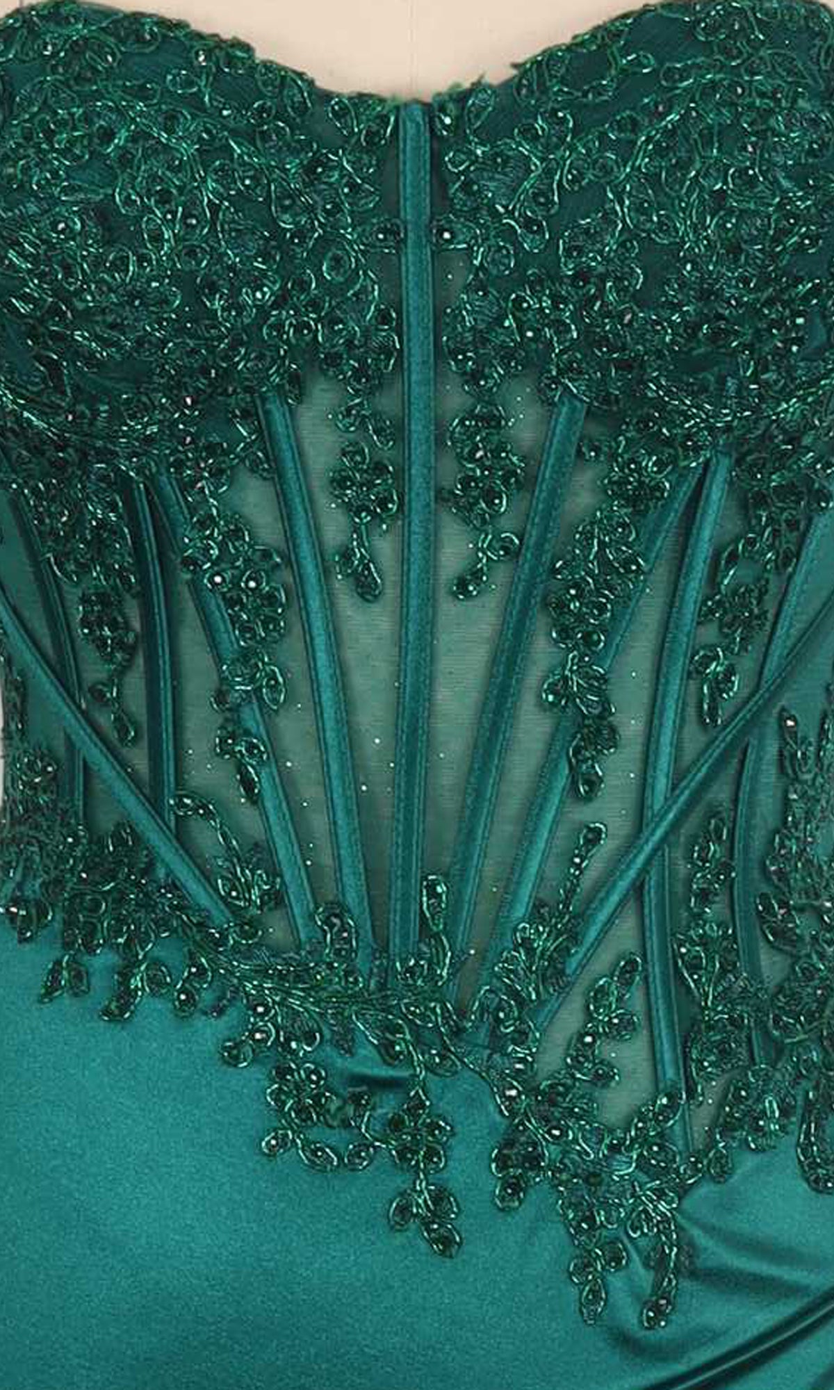 Close-up of an emerald green dress with intricate beading details on a corset bodice