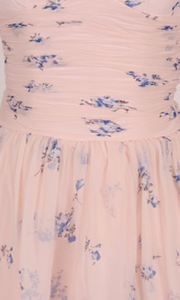 Pink dress with blue floral pattern on a plain background