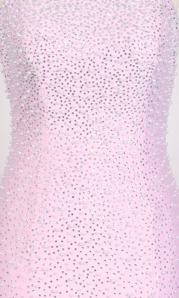 Close-up of the PromGirl Exclusive 250263: a form-fitting, long prom dress in light pink, densely embellished all over with small, shiny rhinestones.