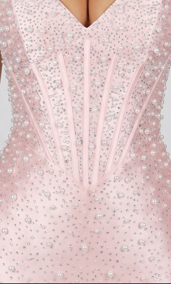 Close-up of the PromGirl Exclusive 250337 short pink mini bodycon homecoming dress with pearl and rhinestone embellishments, structured boning, and a sweetheart corset bodice.