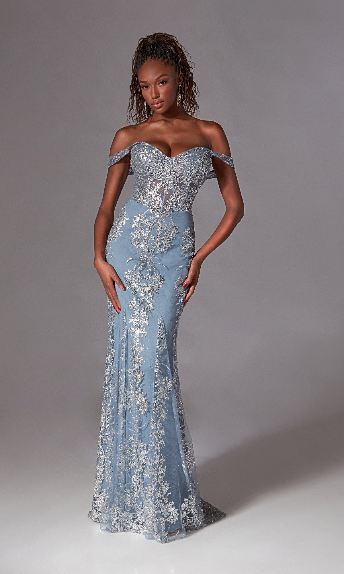 A woman poses against a plain grey background in the Long Blue Glitter Prom Dress: Aerie Couture 252, featuring off-the-shoulder styling and silver floral lace details.
