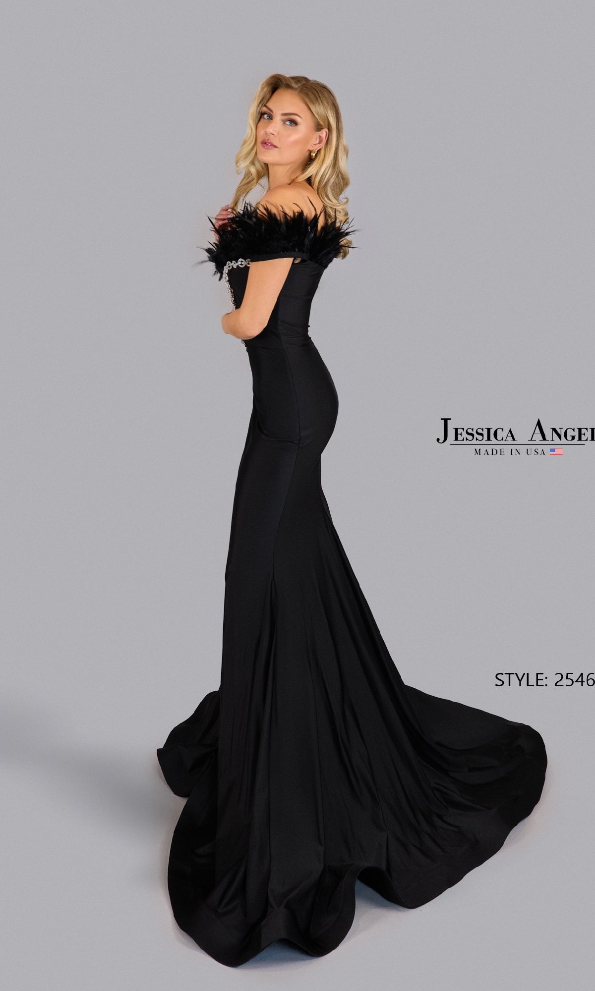 A woman poses against a plain background in the Jessica Angel 2546 Long Prom Dress, a fitted black off-the-shoulder gown with feathers and a long train. Text reads “Jessica Angel” and “Style: 2546.”.