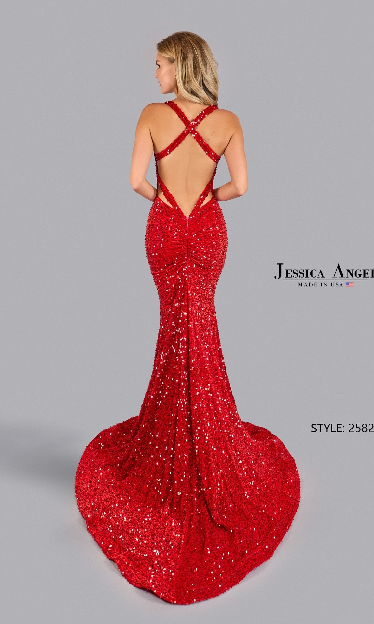 A woman in the Jessica Angel 2582 Strappy Long Sequin Prom Dress with a crisscross open back and mermaid silhouette stands against a plain gray background.