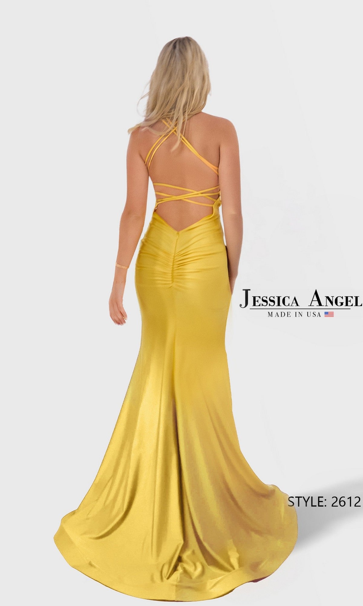 A woman in a floor-length yellow stretch satin jersey mermaid gown with a strappy open back faces away; the image shows the text