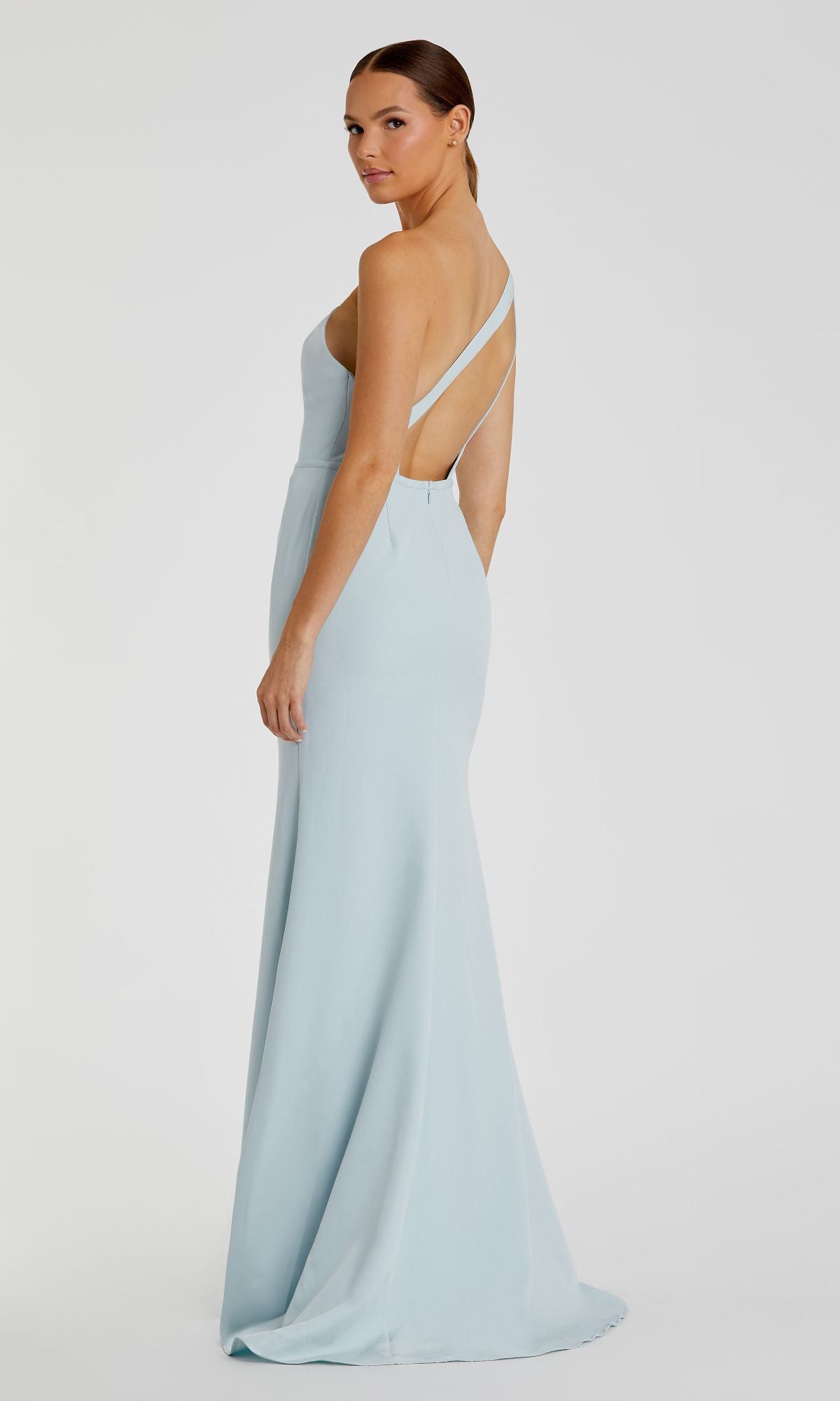 Woman wearing the One-Shoulder Strappy-Back Long Formal Dress 26266 in light blue, featuring a single shoulder and thin straps, stands and looks over her shoulder against a plain background.