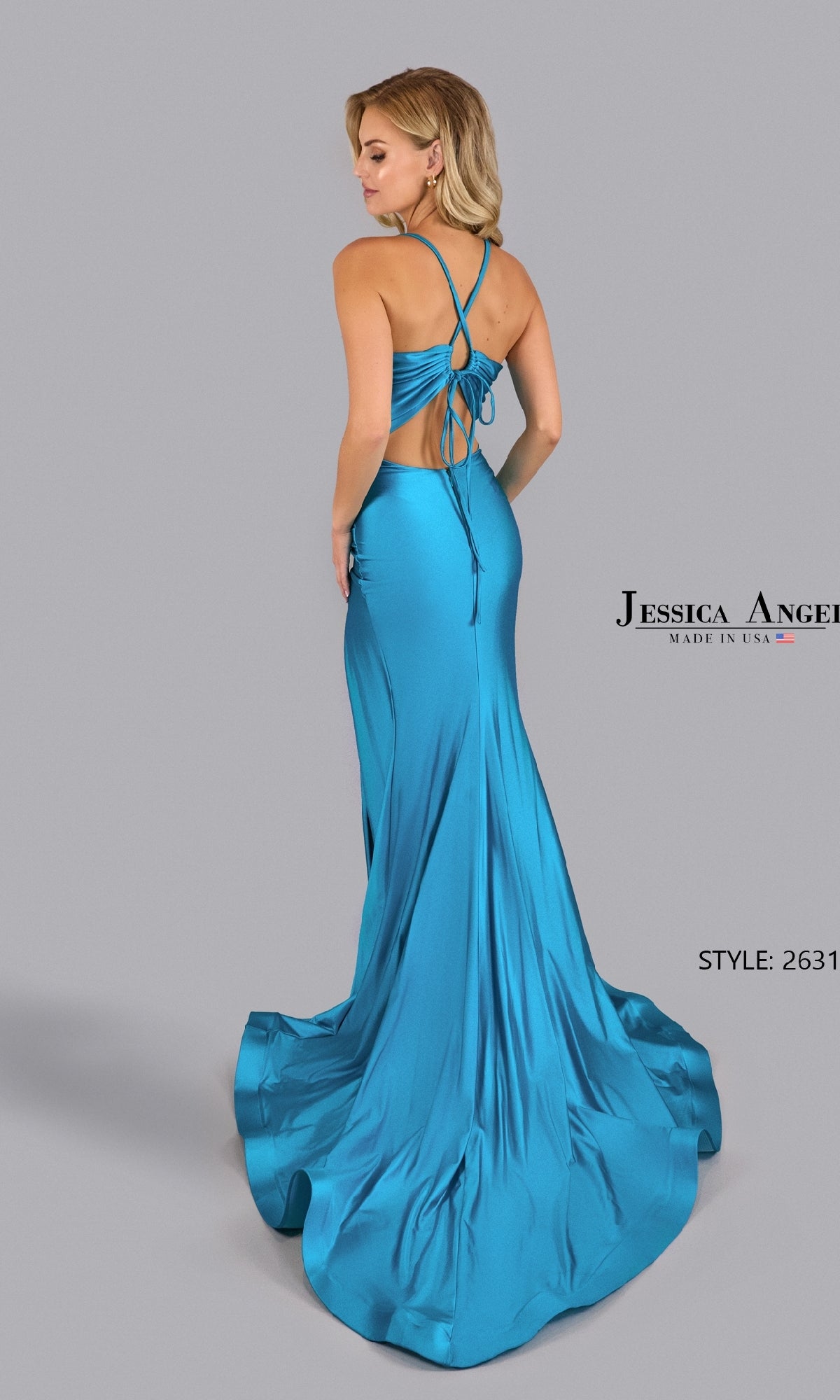 A woman stands on a gray background wearing a turquoise satin Strappy-Back Long Prom Dress—Jessica Angel 2631—with crisscross straps and an open back. Text: