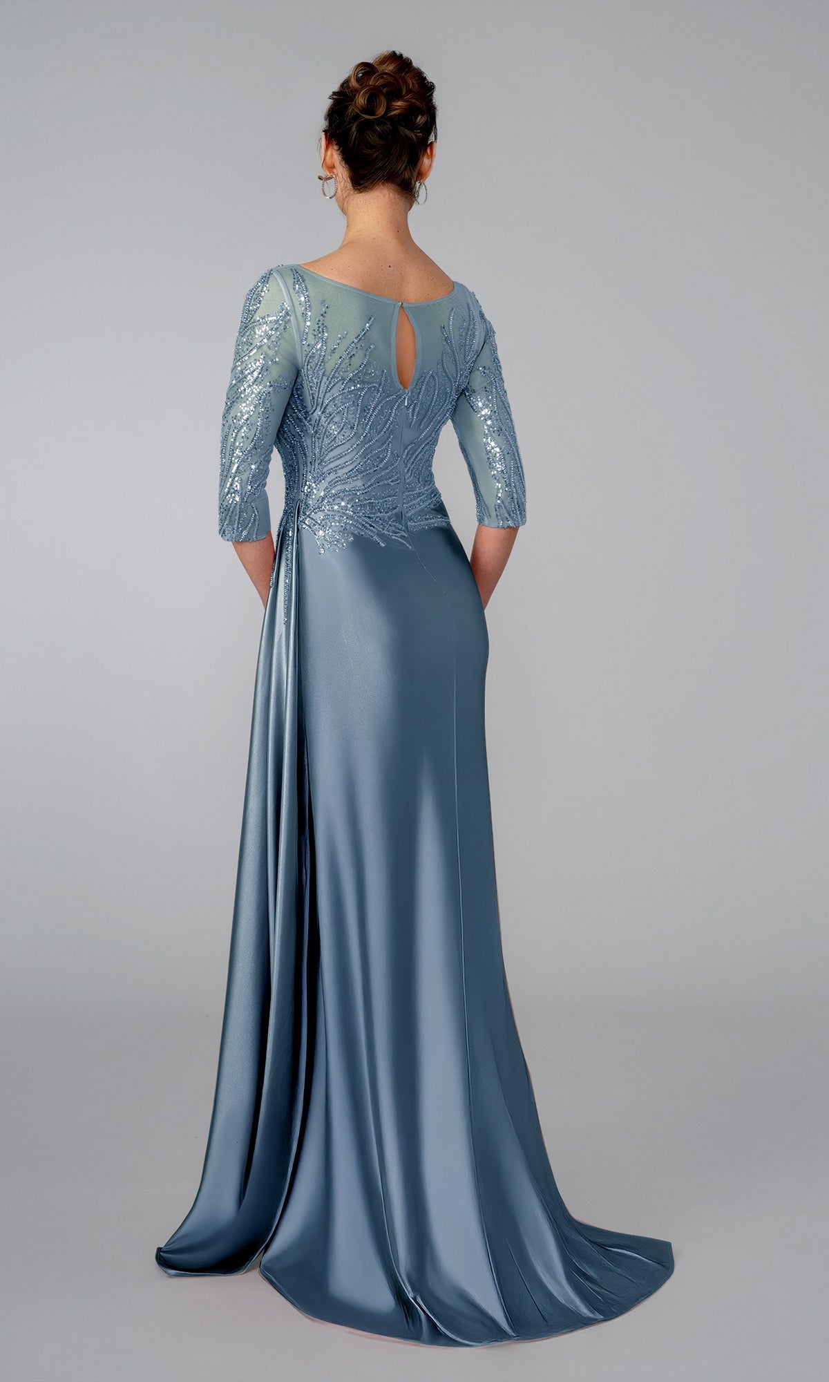 Back view of the Stella Couture 26320 slate-colored evening gown with three-quarter sleeves, a sequined bodice, and a keyhole cutout at the neckline.