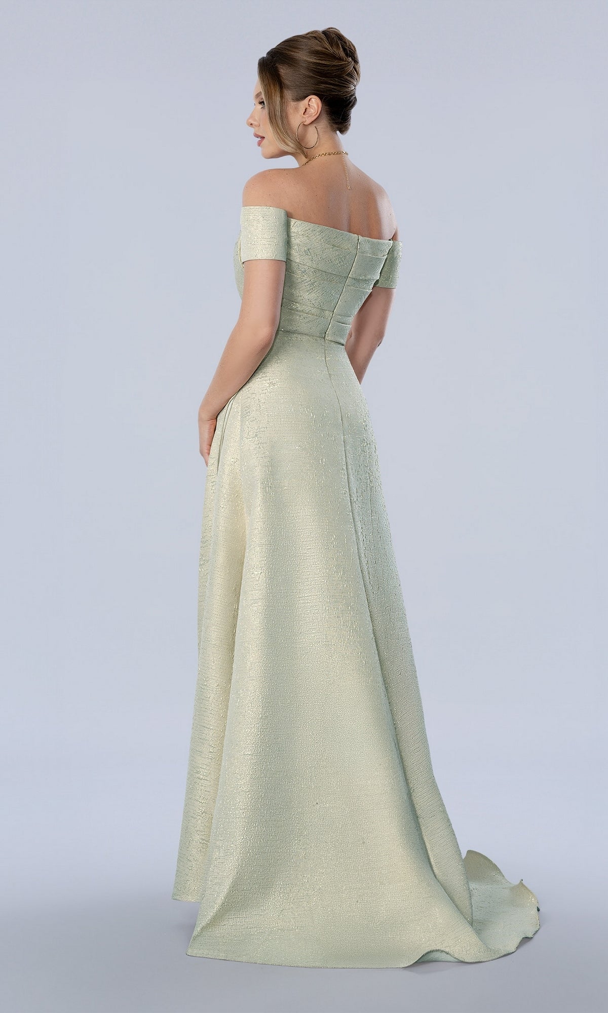Stella Couture 26373 is a mint-colored, off-the-shoulder, floor-length evening gown with a full skirt, a slight train, and a metallic finish.