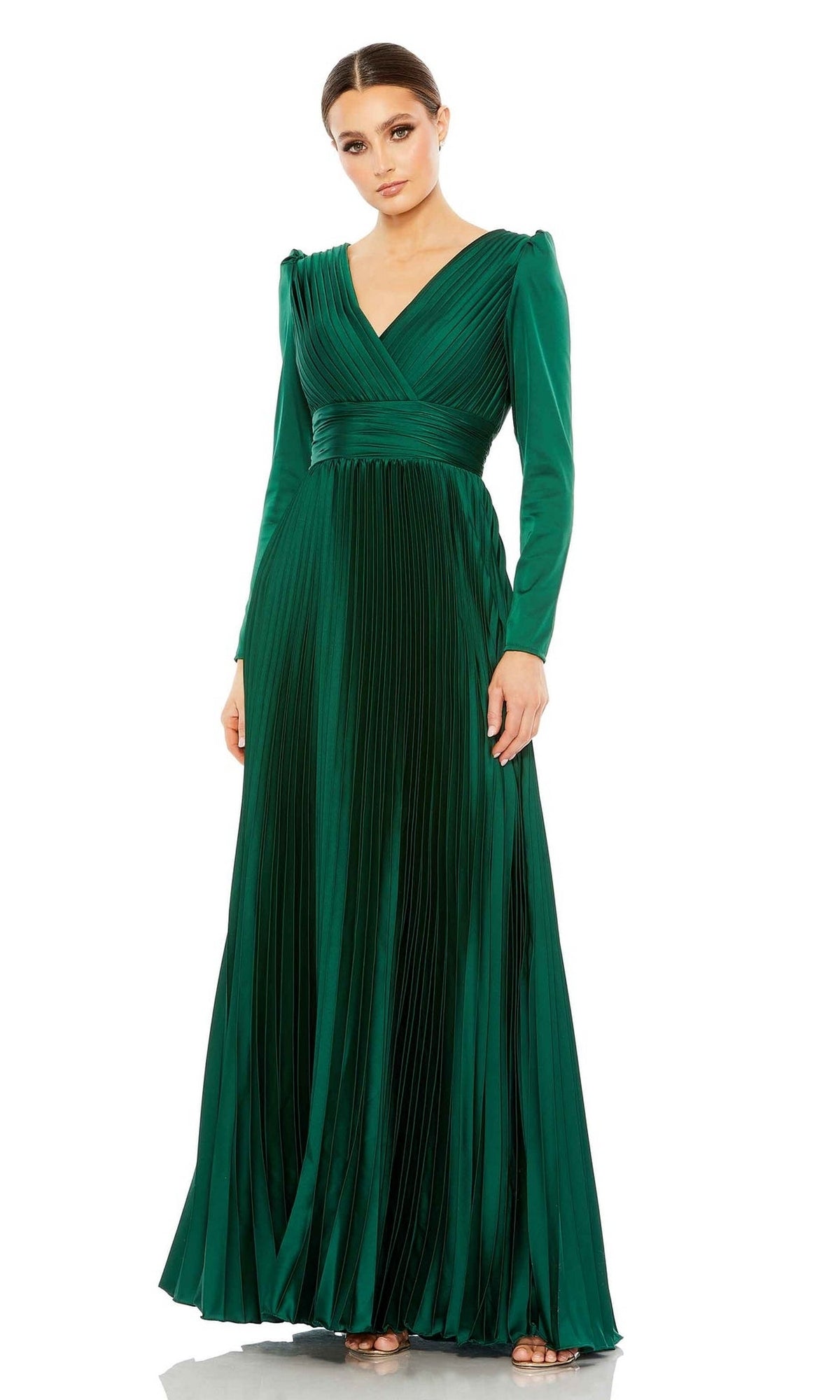 A woman poses against a white background, wearing the Mac Duggal Long Formal Dress 26542—an emerald green, floor-length gown with long sleeves, pleats, a V-neckline, and a cinched waist.