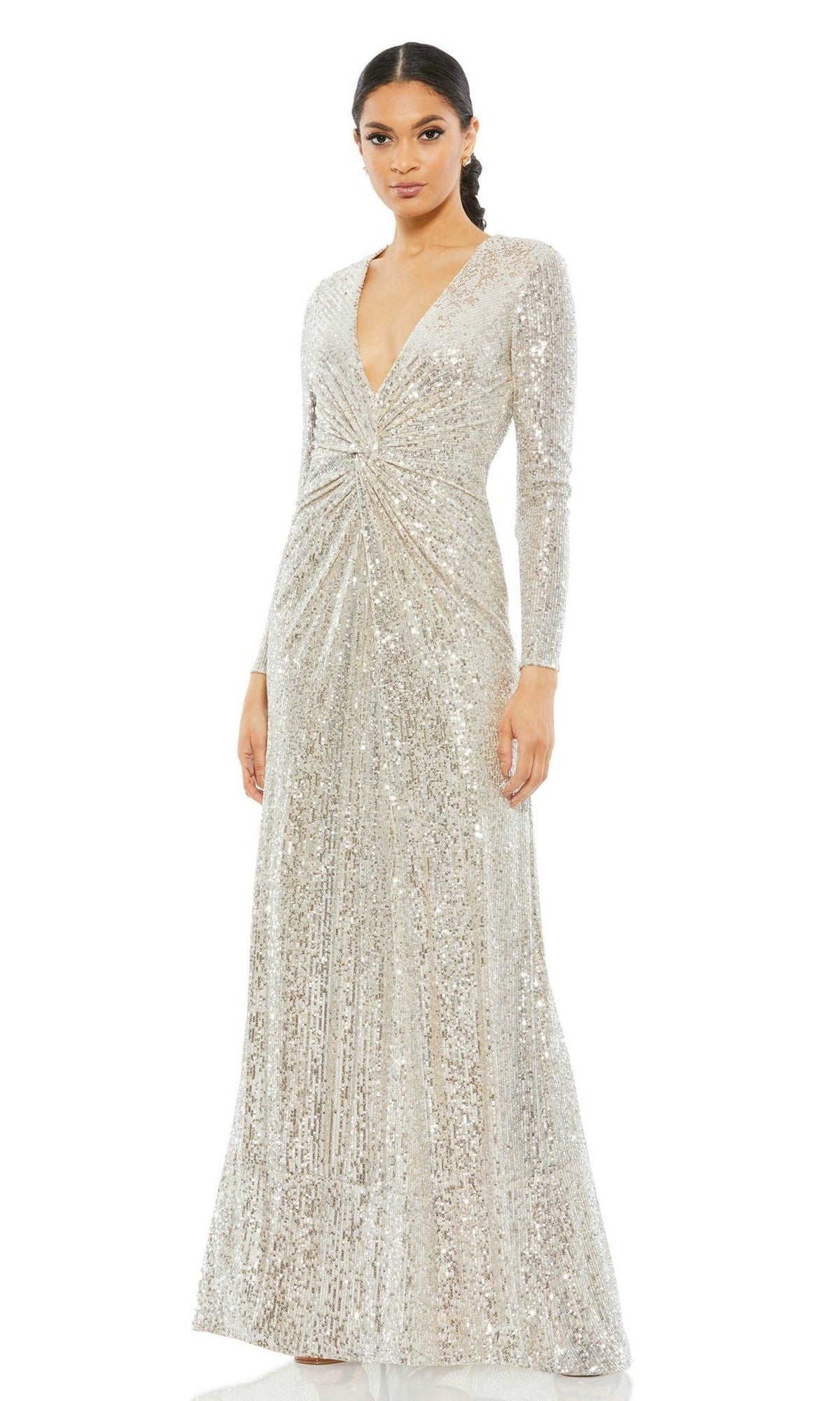 A woman models the Long Formal Dress 26552 by Mac Duggal, a floor-length silver sequin gown with long sleeves, deep V-neckline, and gathered waist detail, standing against a white background.