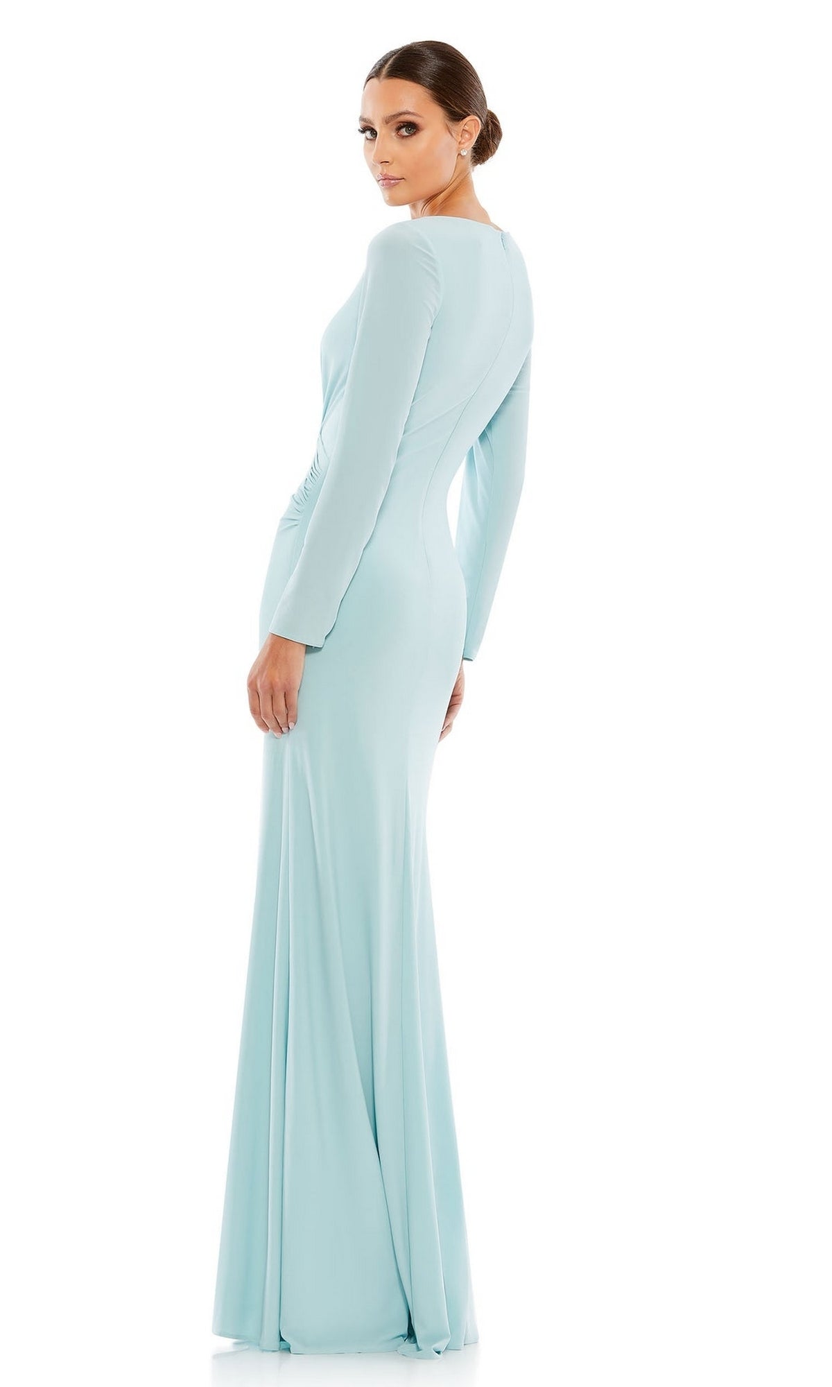A woman wearing the Mac Duggal 26573 Long Sleeve Long Formal Dress in light blue stands facing away, looking over her shoulder against a white background.