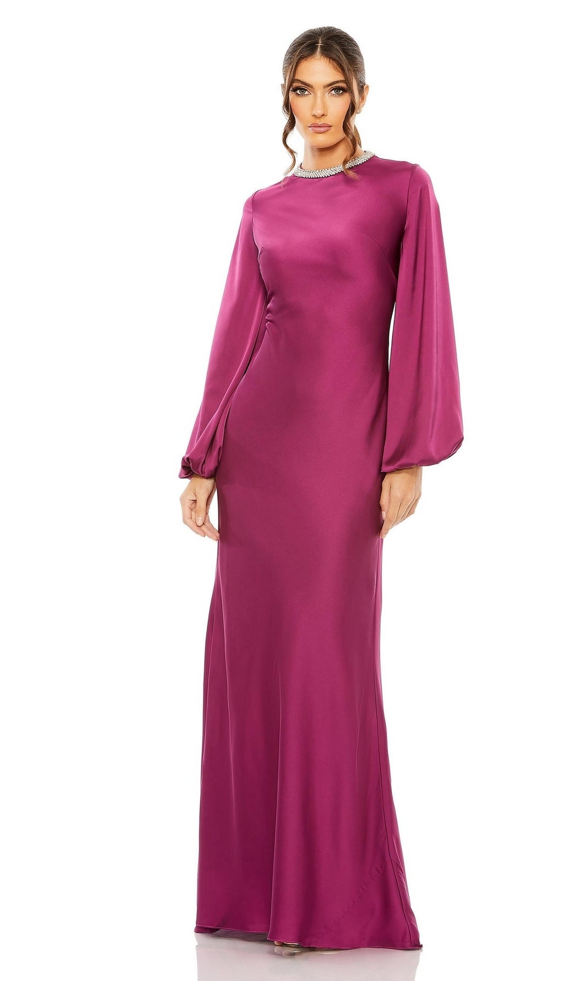 A woman in the Mac Duggal 26575 long sleeve, floor-length magenta satin formal dress stands facing forward against a plain white background.