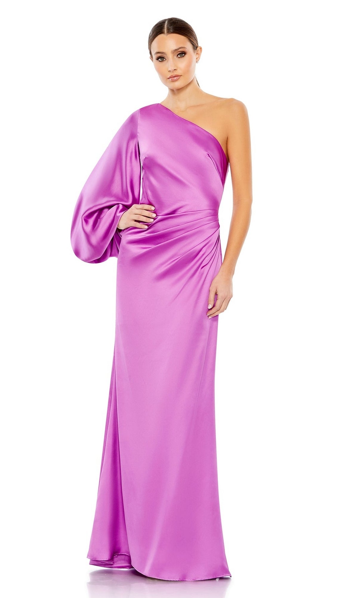 A woman stands against a white background in the Mac Duggal 26588, a shiny floor-length formal dress featuring a one-shoulder design and dramatic voluminous sleeve.