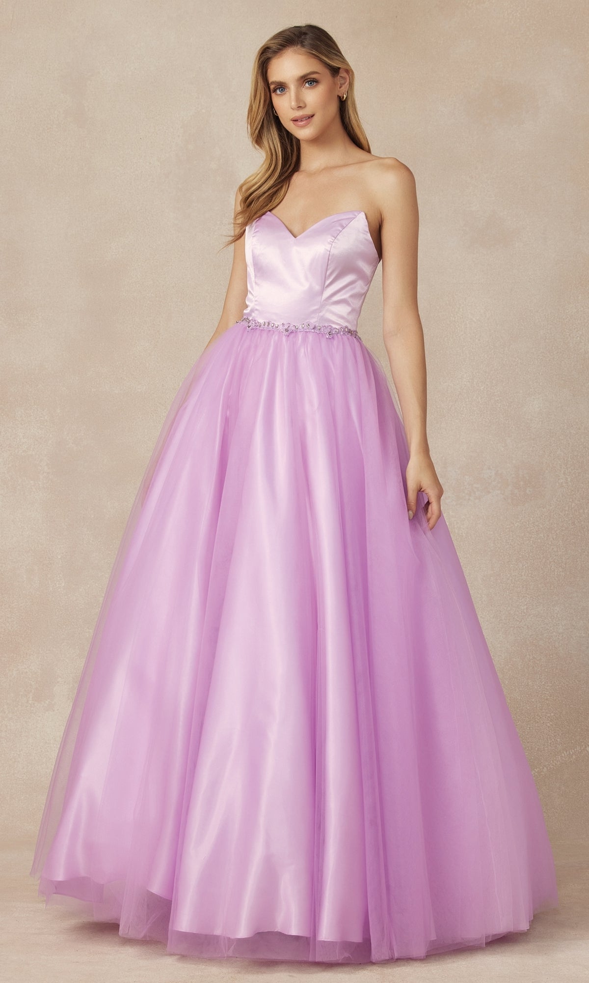 A woman in the Strapless Sweetheart Long Prom Ball Gown 265, featuring a fitted satin bodice, corset back, and full lilac tulle skirt, stands against a neutral background.