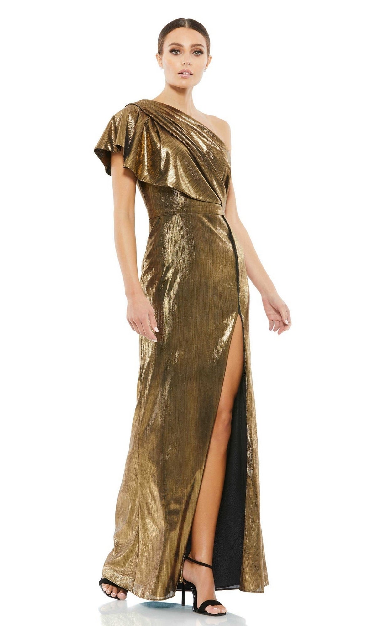 A woman wearing the Long Formal Dress 26600 by Mac Duggal in metallic bronze, featuring a one-shoulder design and thigh-high slit, pairs it with black high-heeled sandals as she stands against a white background.