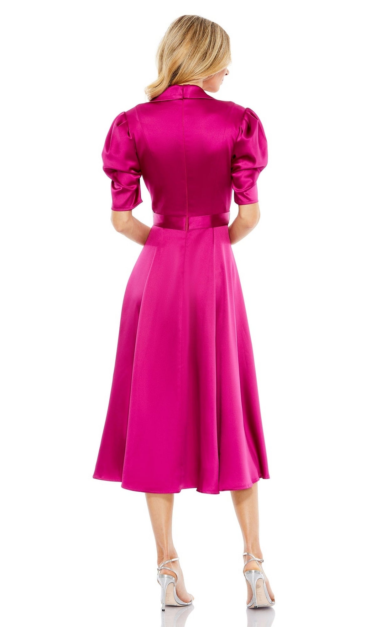 A woman faces away, wearing the Mac Duggal 2628 Short Sleeve Wedding Guest Dress in bright pink with puff sleeves and white high heels, set against a plain white background.