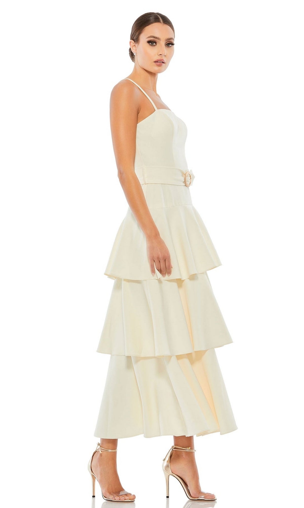 Woman in profile wearing the Short Wedding Guest Dress 26629 by Mac Duggal—a sleeveless, ruffle-layered dress with a belted waist—paired with high-heeled sandals.