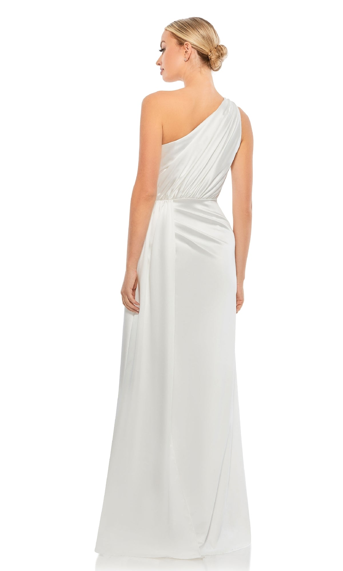 A woman with a neat low bun faces away, styled in the elegant Mac Duggal 26654—an evening gown featuring a Grecian-inspired, gathered waist and a subtle sheen, showcasing its sophisticated one-shoulder design.