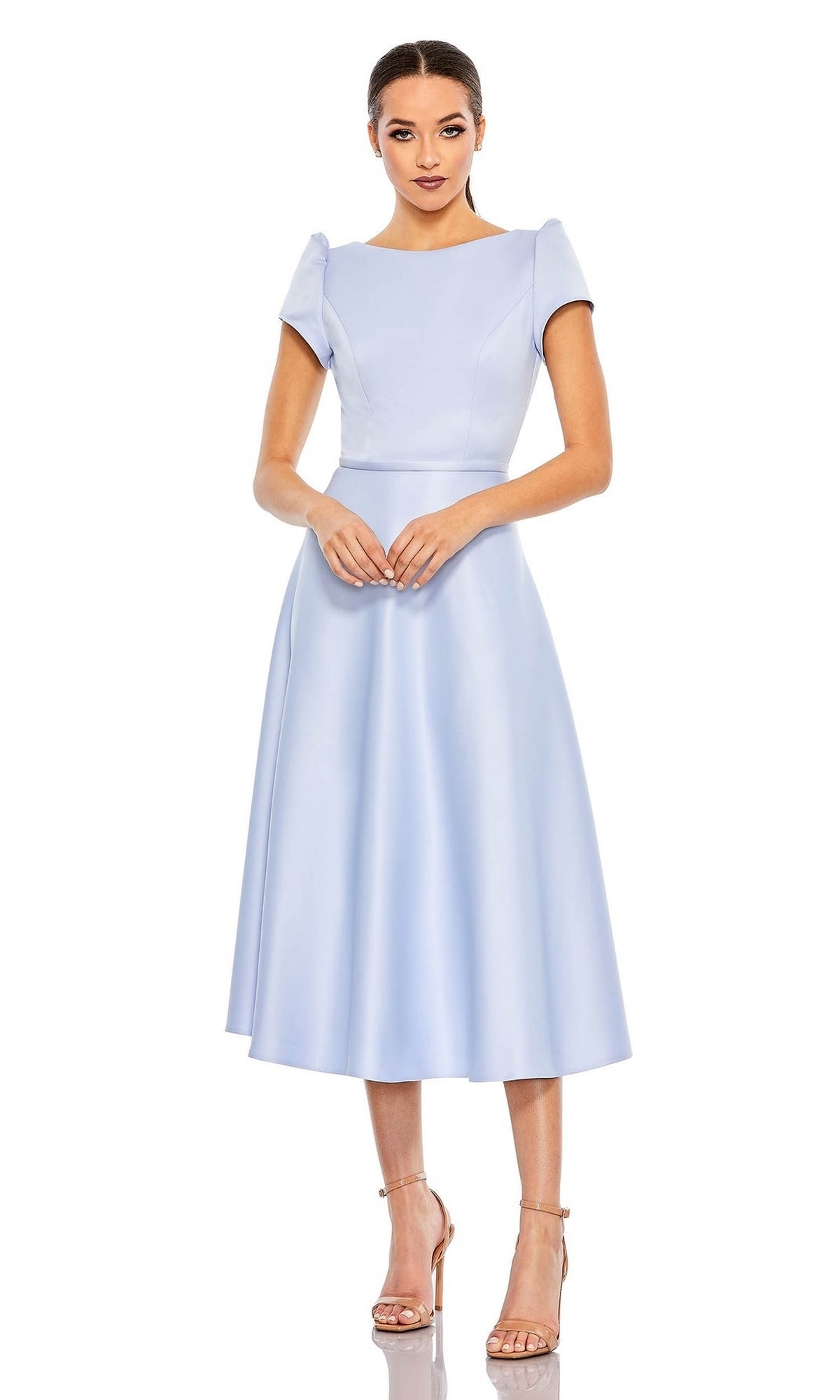 A woman stands against a white background wearing the Short Wedding Guest Dress 26663 by Mac Duggal, featuring a light blue pastel hue, fitted bodice, flared skirt, and nude high-heeled sandals.
