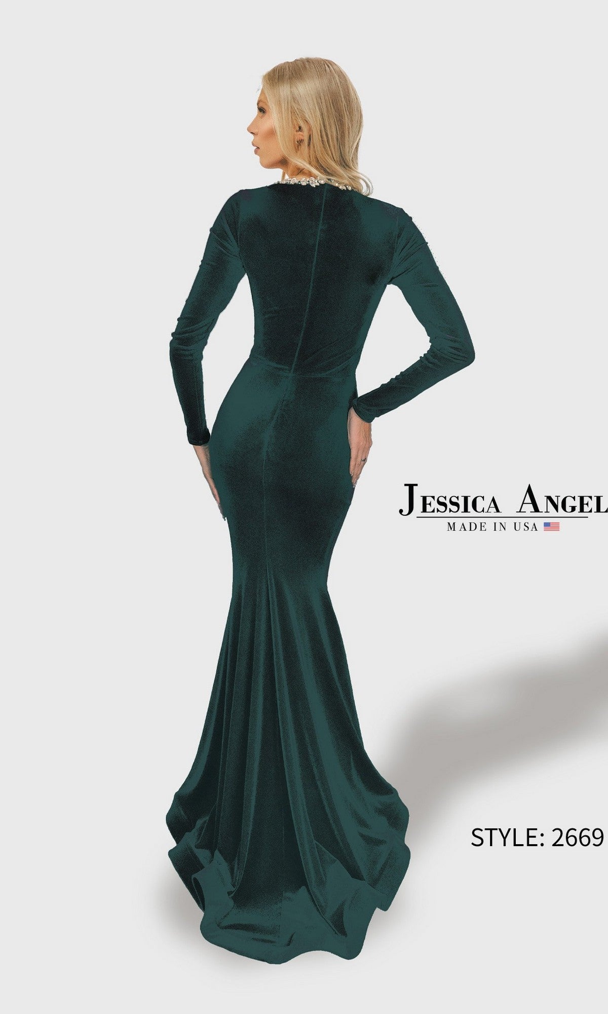 A woman faces away in a fitted dark green Long Prom Dress: Jessica Angel 2669, featuring long sleeves, a floor-length silhouette, and a slight train for sophisticated elegance.