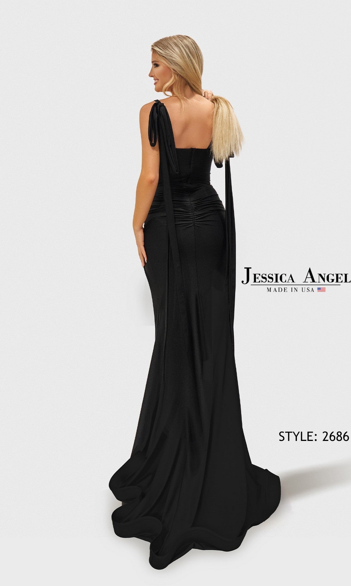 A woman in a long, fitted black Jessica Angel 2686 prom dress with shoulder ties faces away, showcasing its dramatic floor-length train. Text reads