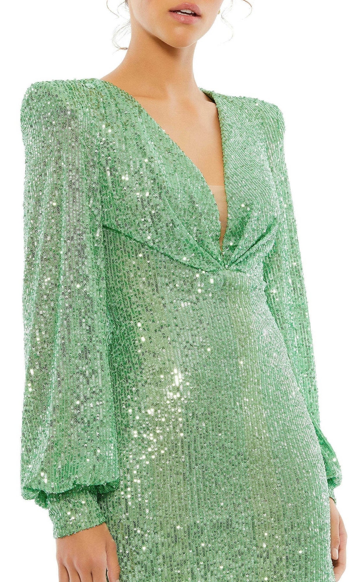 A woman wears the Mac Duggal 26865 Long Sleeve Sequin Hoco Dress—a shiny light green style with puffed sleeves and a deep V-neckline.
