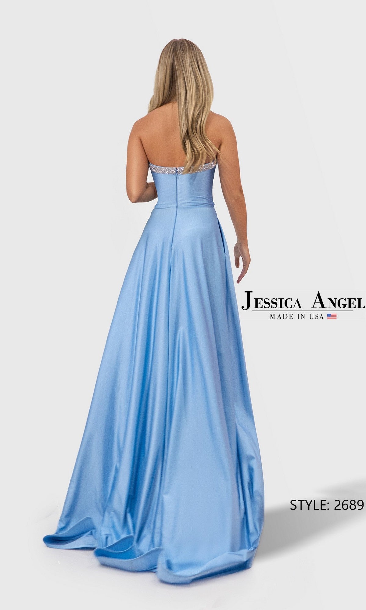 Woman in a light blue, strapless, floor-length satin-jersey prom dress (Jessica Angel 2689) stands facing away to highlight the elegant back.