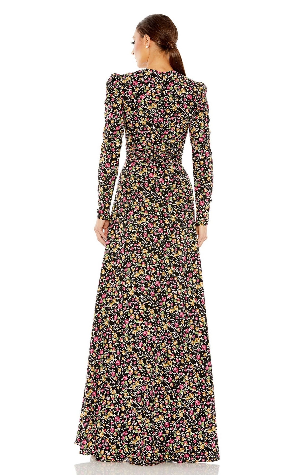 A woman faces away, wearing the Long Formal Dress 26916 by Mac Duggal—a floor-length black gown with long sleeves and a vibrant floral pattern.