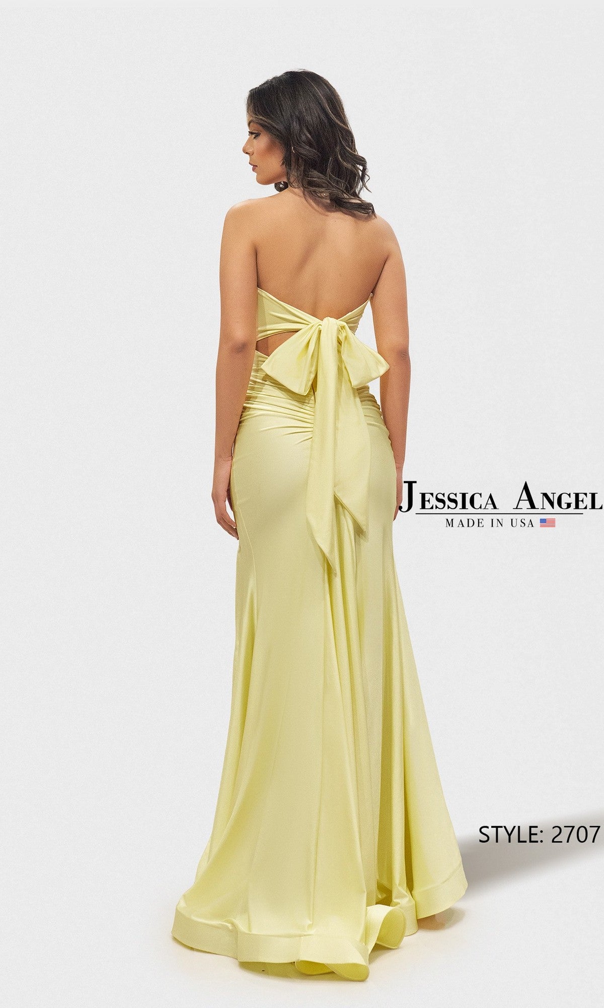 A woman wears the Long Prom Dress: Jessica Angel 2707, a strapless light yellow gown with a large back bow, posing against a white background. The text displays