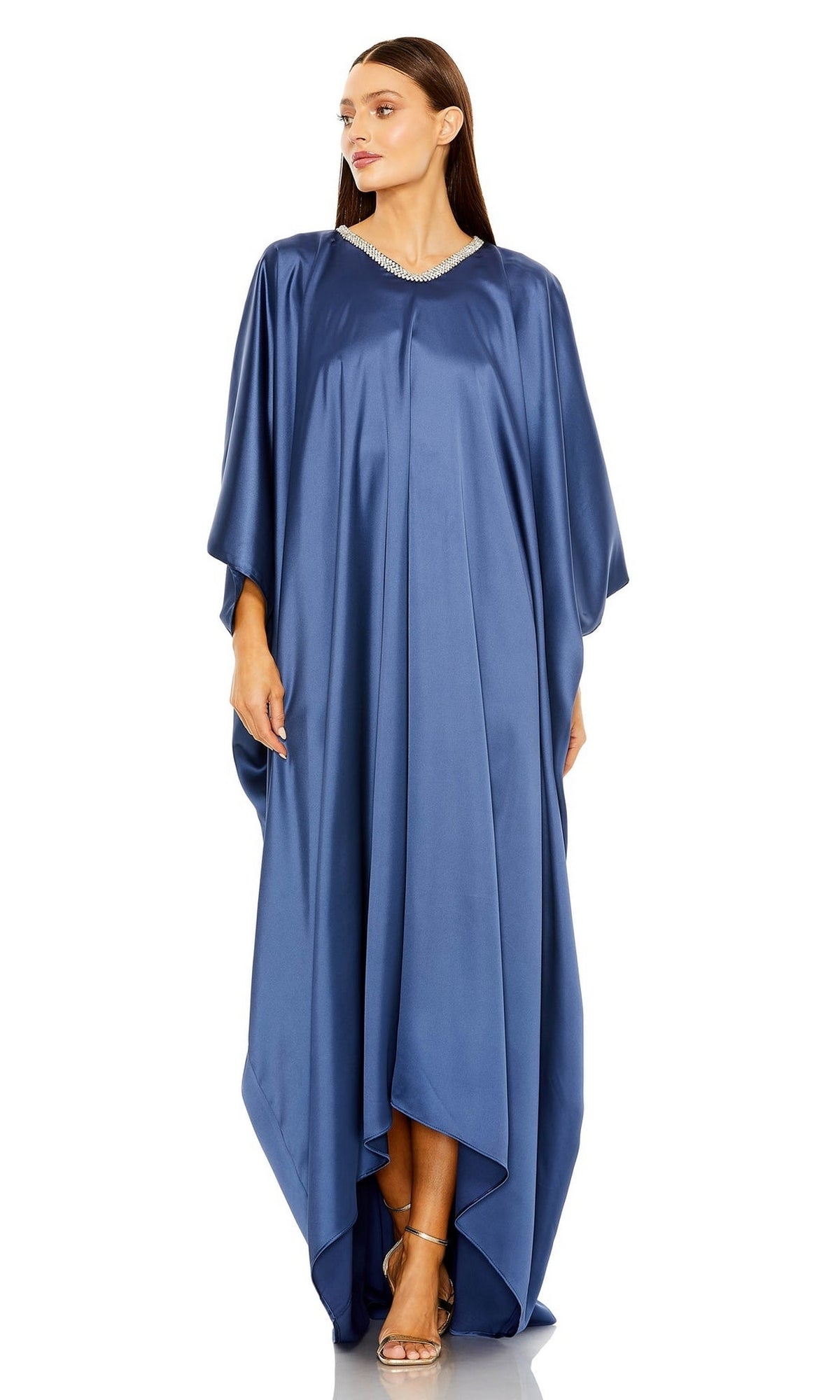 Woman wears the Mac Duggal Long Formal Dress 27071, a loose-fitting, floor-length ocean blue gown with a V-neckline and short wide sleeves, posing neutrally.