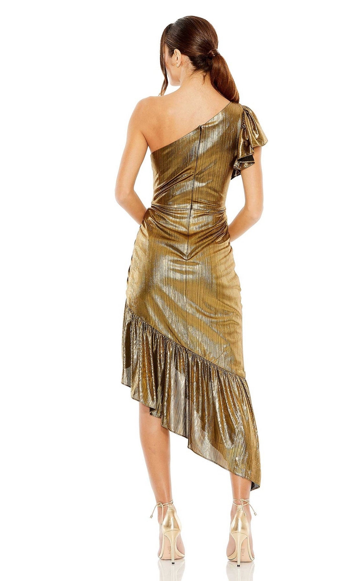 A woman in the Short Wedding Guest Dress 27075 by Mac Duggal stands facing away, showcasing its shiny gold one-shoulder design with an asymmetric ruffled hem, styled with a ponytail and high heels for a chic party look.