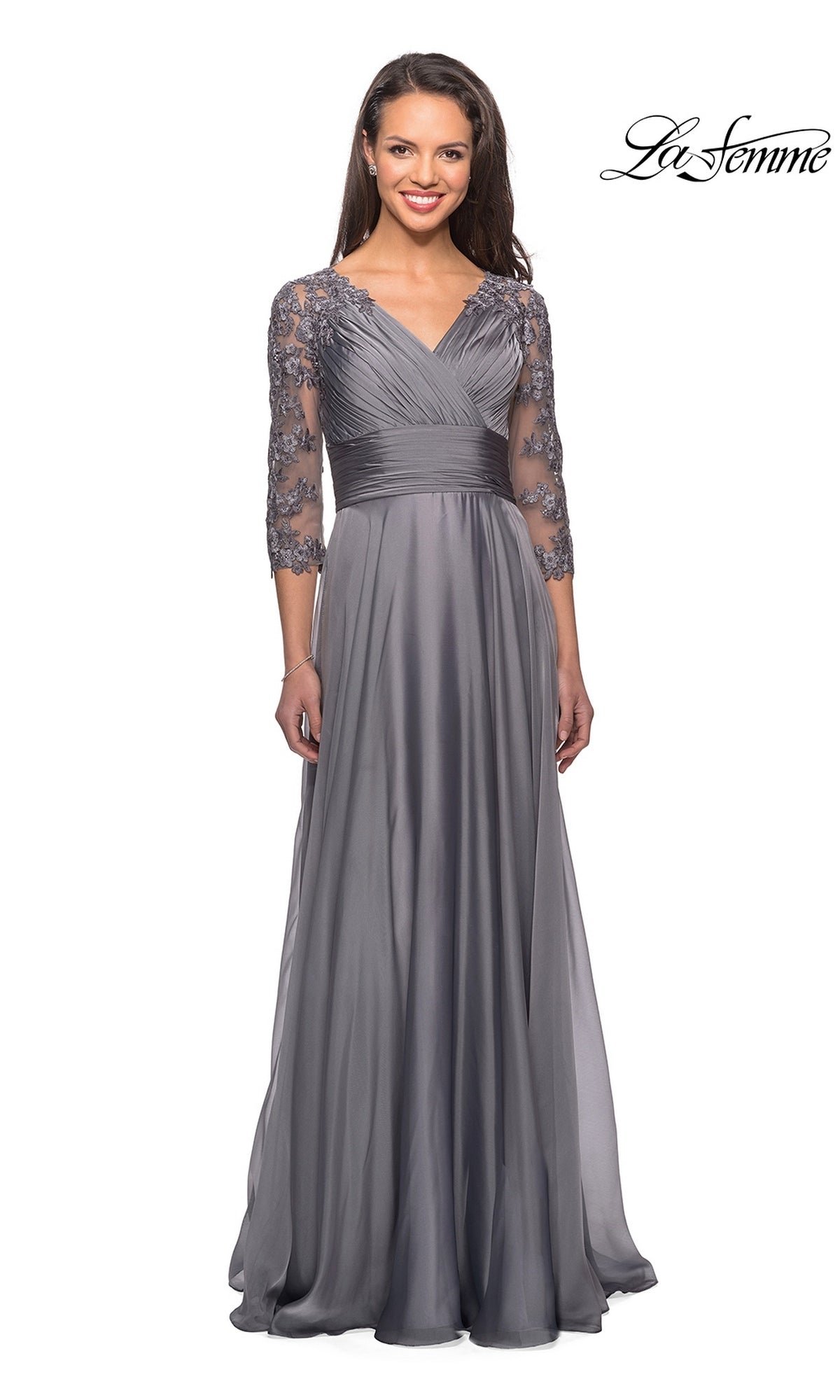 The La Femme 27153 is a platinum-colored, modest formal dress with a V-neckline, ruched bodice, and three-quarter length floral lace sleeves.