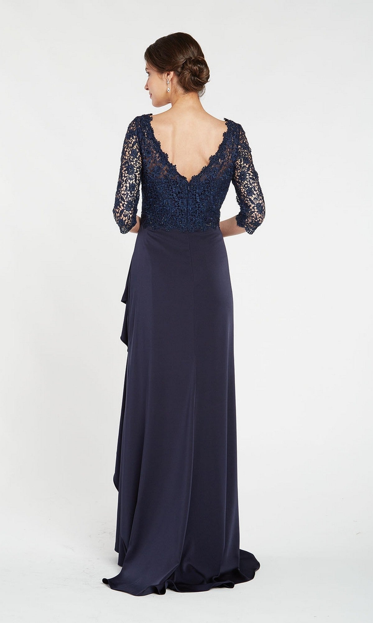 A woman faces away, modeling the Alyce 27242 long formal dress in navy blue with a beaded lace bodice, three-quarter sleeves, and a V-back, set against a plain white background.