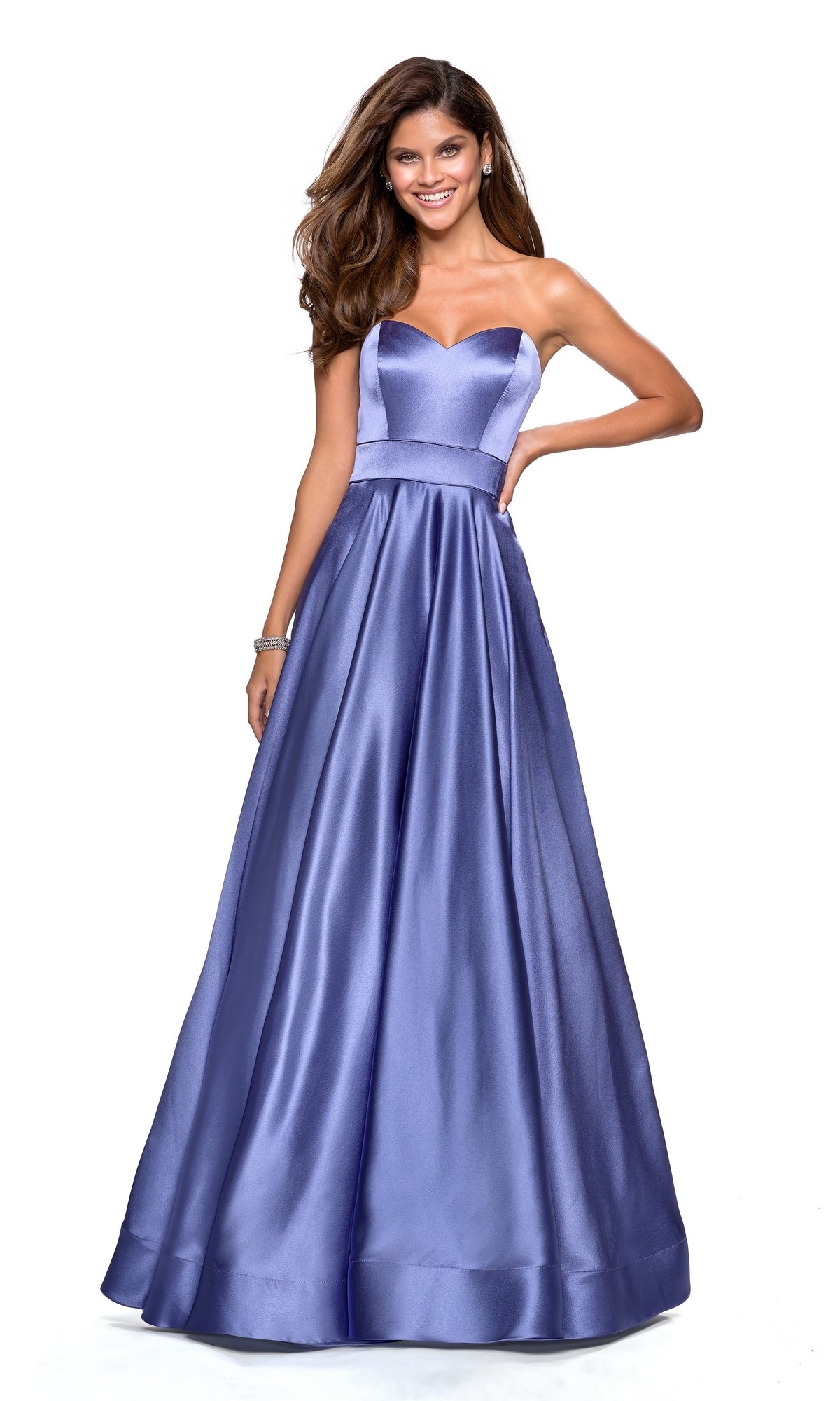 A woman poses against a white background wearing the Strapless A-Line Satin Prom Dress: La Femme 27506, a lavender gown with a fitted bodice and flared skirt.