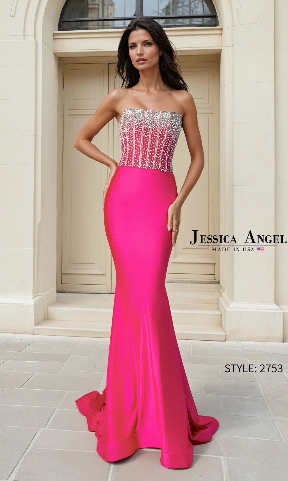 A woman stands before double doors in the Jessica Angel 2753 Long Prom Dress, a strapless dark neon pink mermaid satin gown with a crystal-embellished corset bodice.