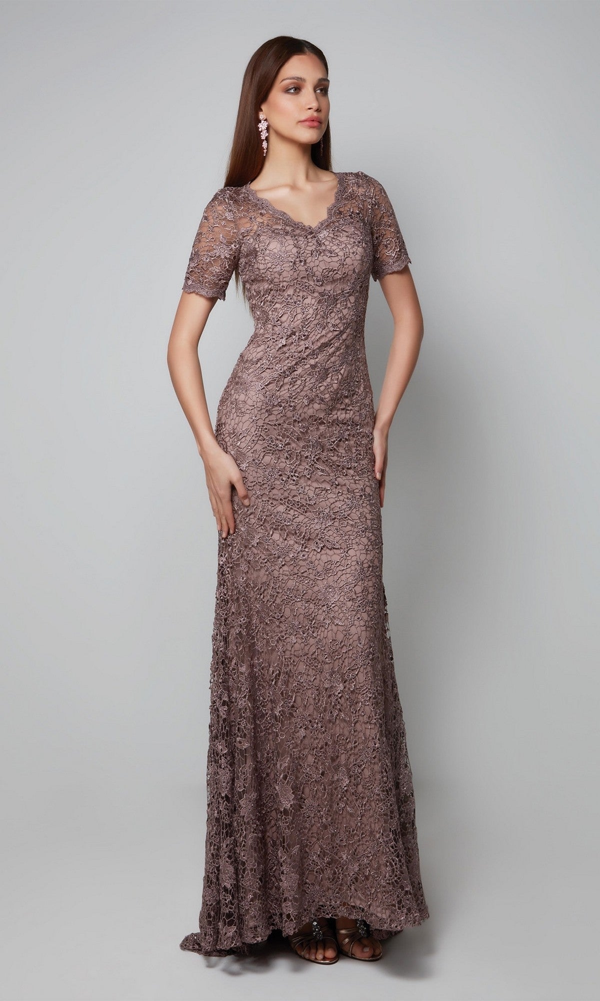 Woman wearing the Alyce 27561 long formal dress in smoke, featuring short sleeves and a V-neckline, perfect as a mother-of-the-bride gown, standing against a plain light gray background.