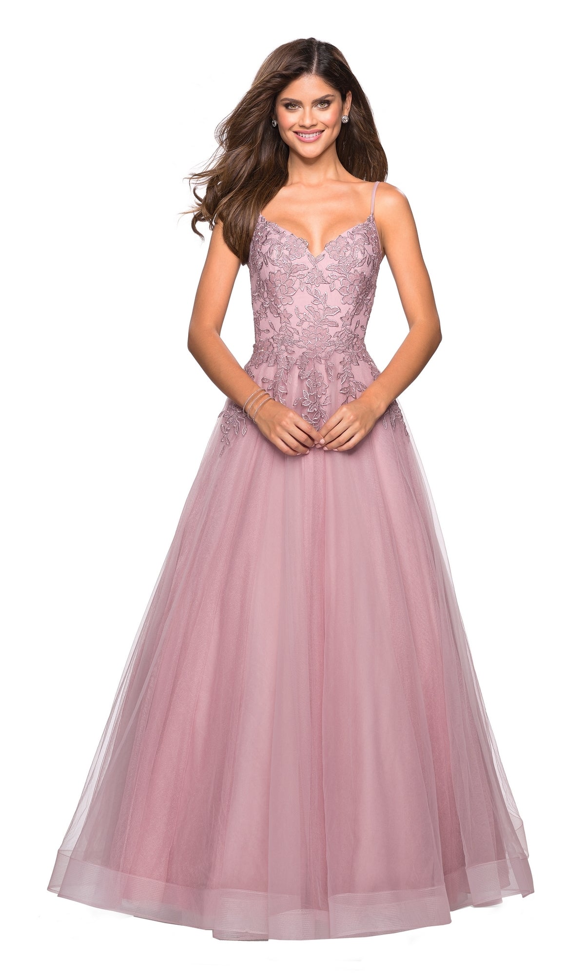 A woman smiles against a white background wearing the La Femme 27569 Cut-Out Embroidered Tulle Prom Dress—a floor-length, sleeveless mauve gown with a lace bodice and delicate floral embroidery.