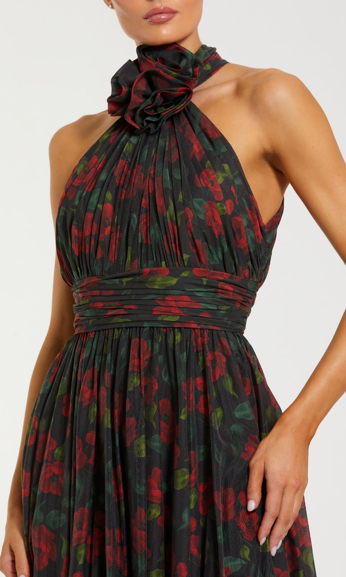 Woman wearing a floral halter neck dress on a white background