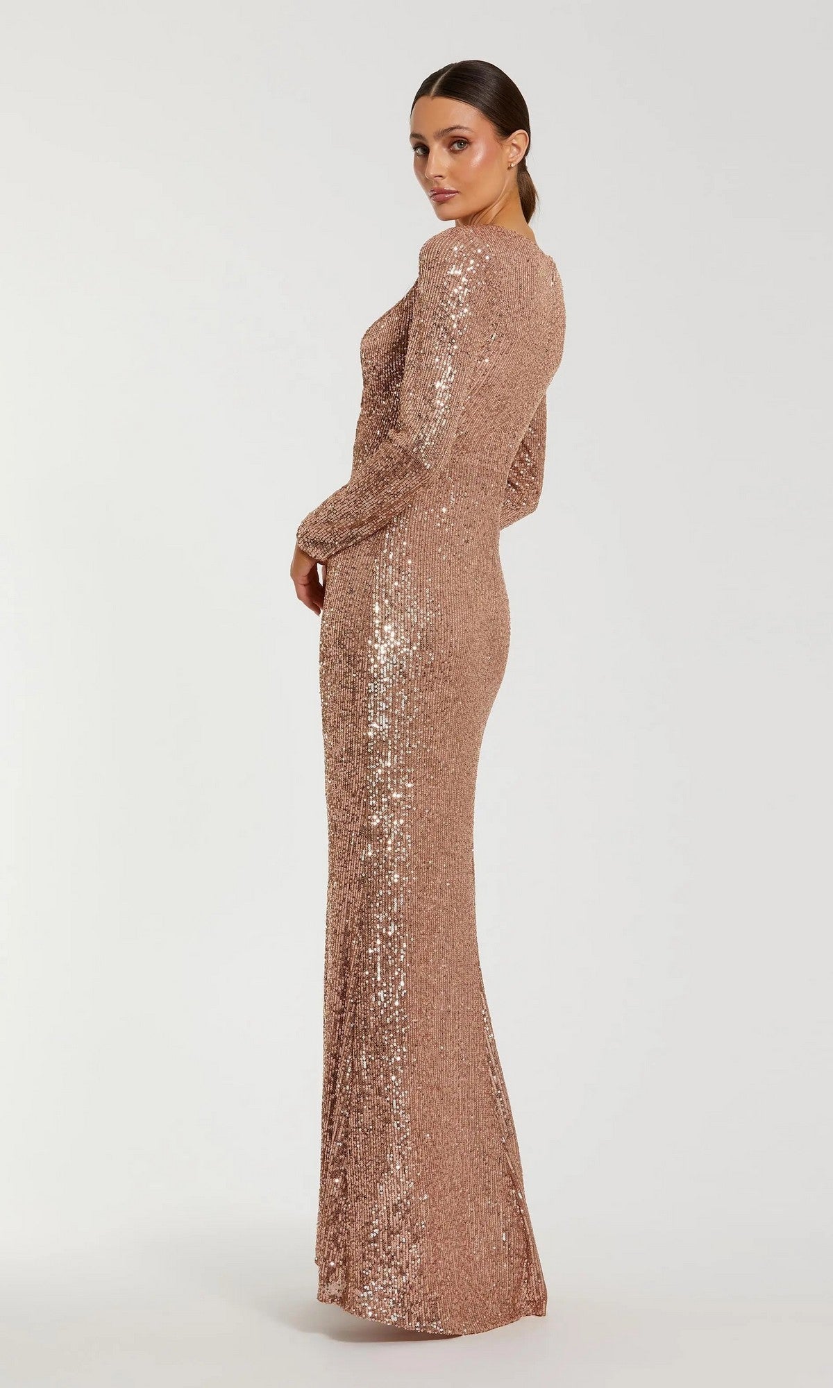A person poses against a plain light background wearing the Mac Duggal 27700 long formal dress, featuring sequins and 3D floral detailing on the shoulders.