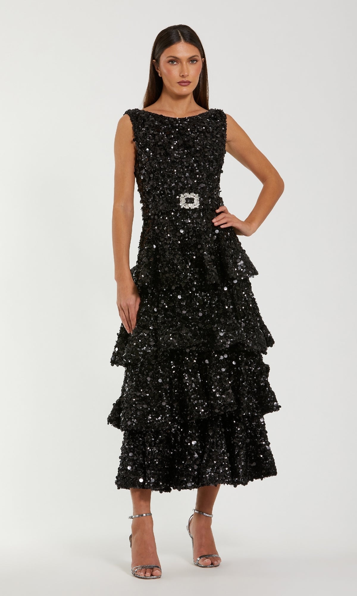 Woman wearing a black sequin dress on a white background