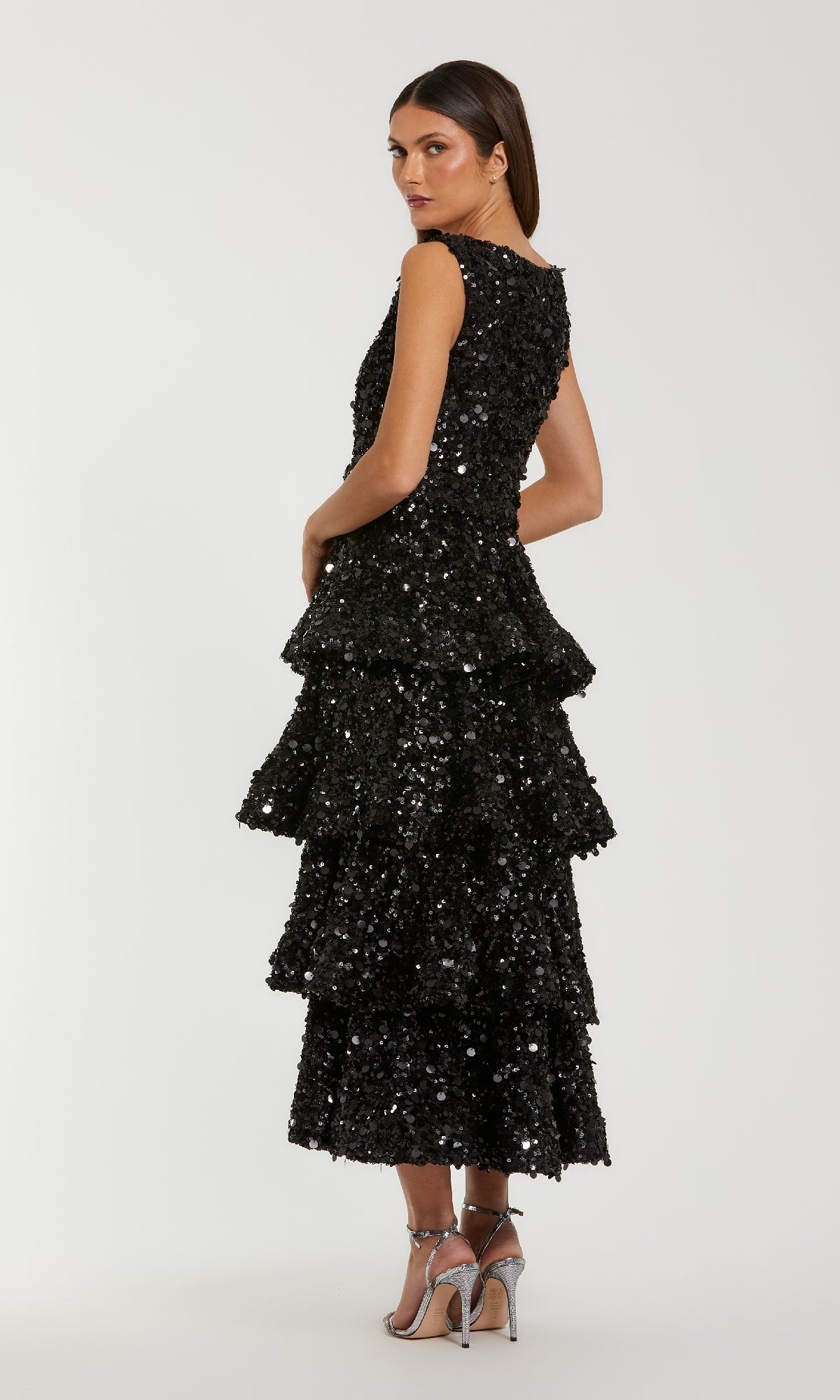 Black sequin dress with tiered layers on a white background