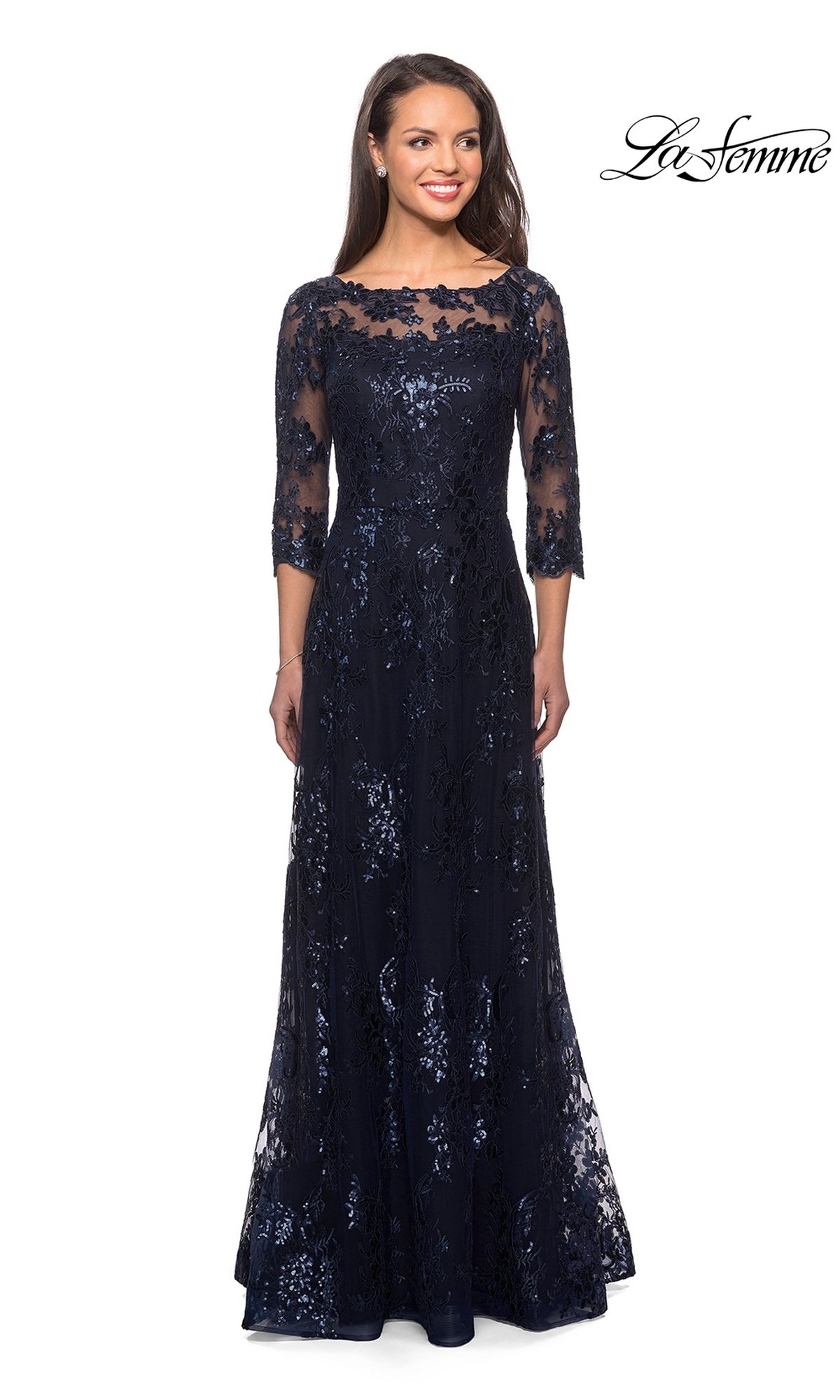 A woman wears a navy blue La Femme 27885 long formal dress with an A-line skirt, three-quarter sleeves, sequin-lace detailing, and an illusion neckline.