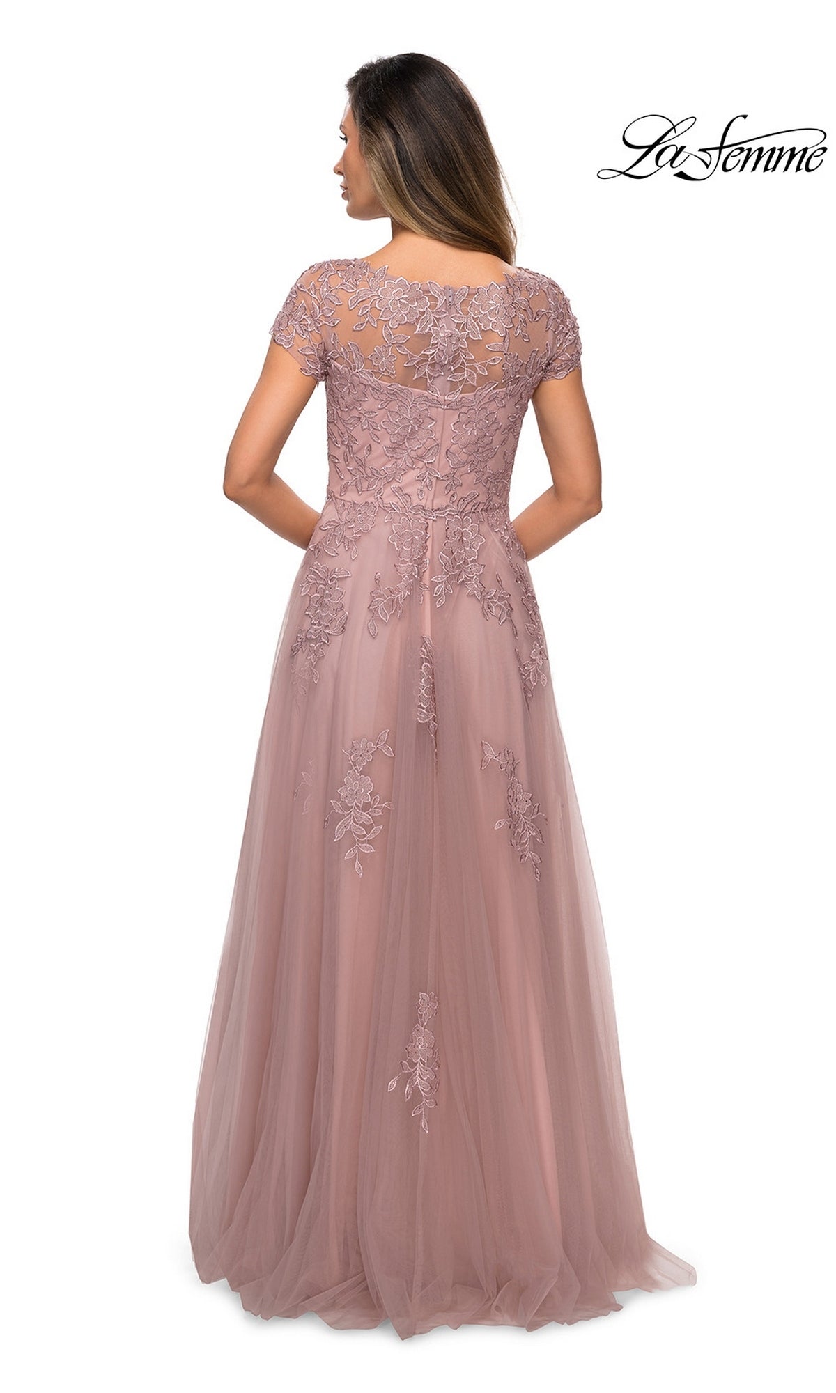 Woman in mauve Long Formal Dress: La Femme 27920—A-line, floor-length, short sleeves, floral lace embroidery, sheer upper back. “La Femme” logo top right.