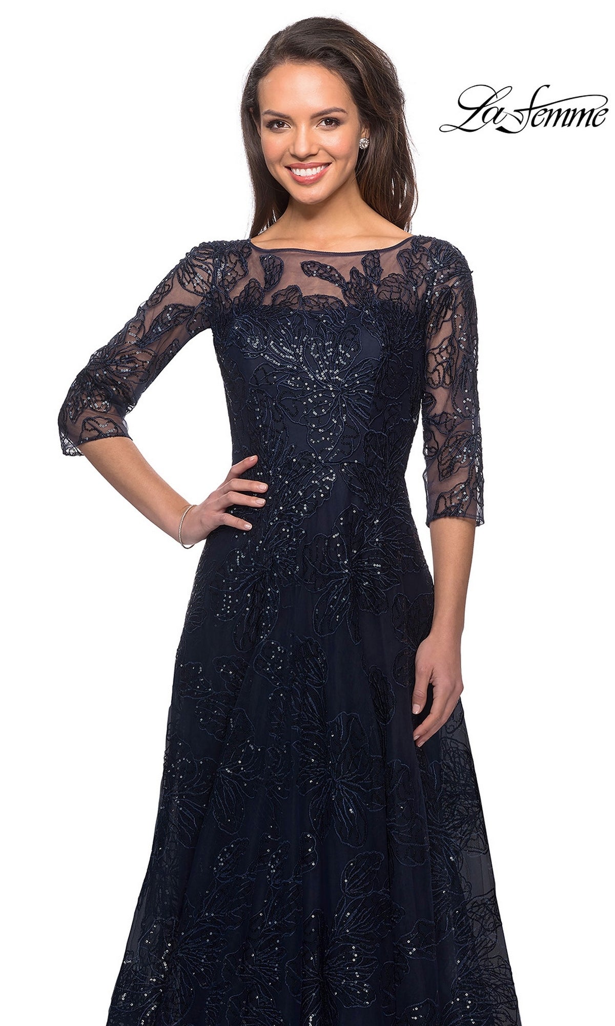 Woman in a navy sequined lace Long Formal Dress: La Femme 27942 with three-quarter sleeves, smiling against a white background. “La Femme” logo in top right corner.