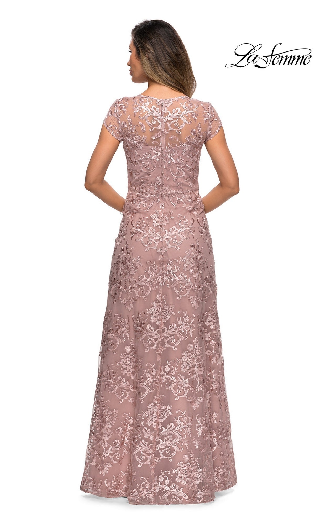 Back view of a woman in a mauve, floor-length La Femme 27951 gown featuring short sleeves and intricate floral embroidery.