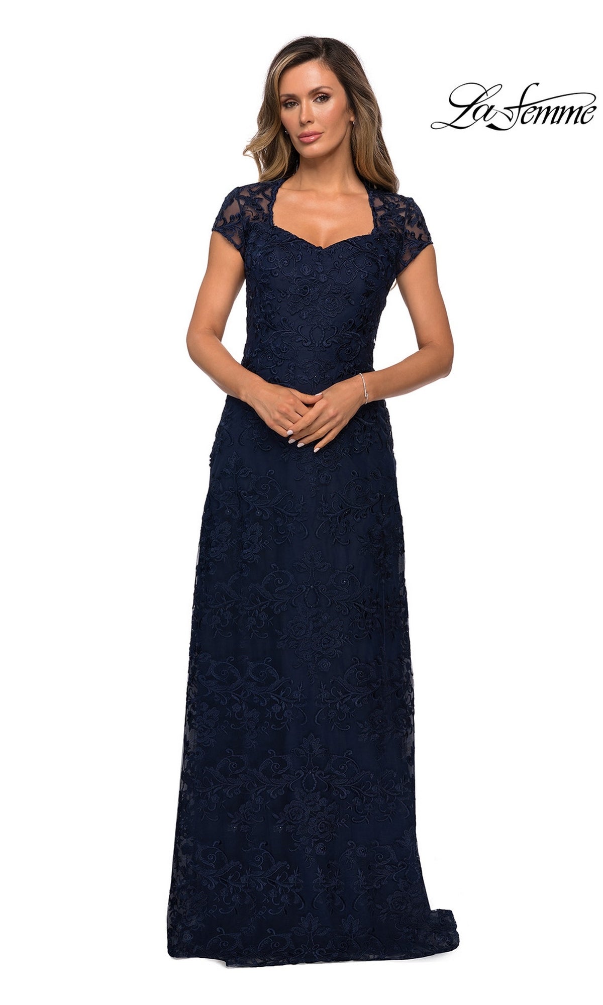 Woman wearing a navy blue, floor-length La Femme 27951 formal dress with short lace sleeves and a sweetheart neckline.