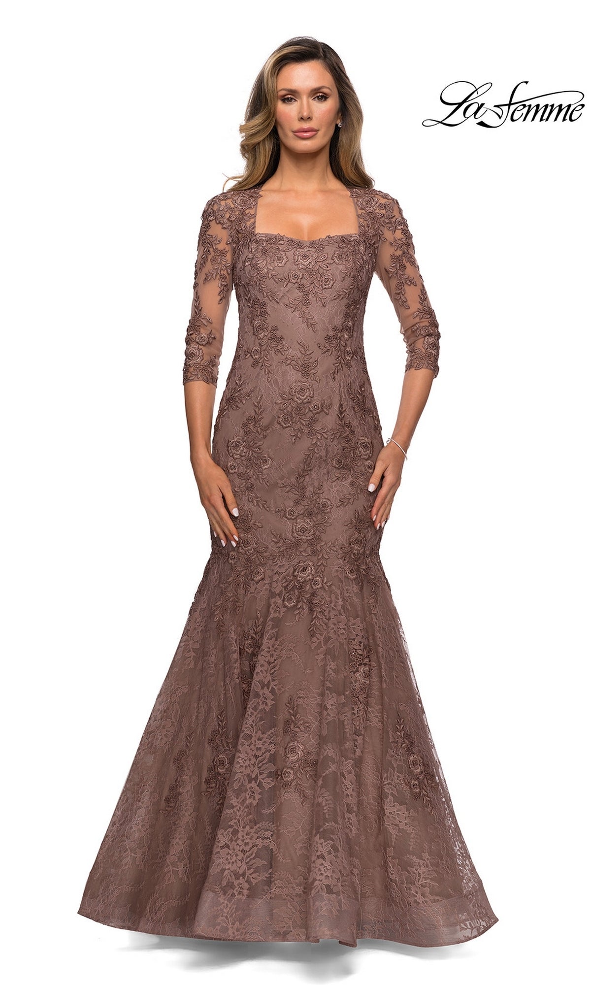 Woman wearing the Long Formal Dress: La Femme 28033 in cocoa, featuring floral lace, three-quarter sleeves, and a square neckline. “La Femme” logo shown top right. White background.