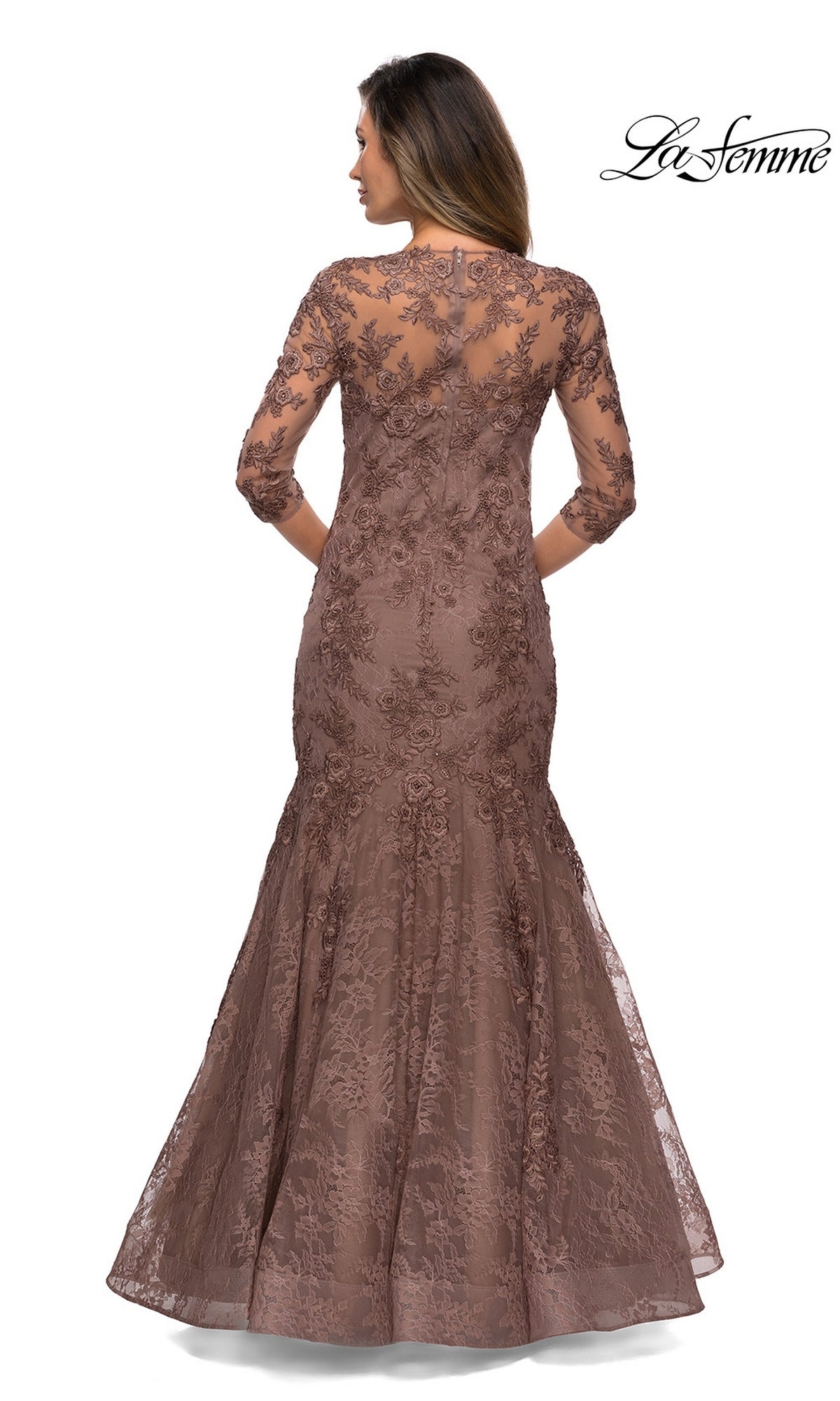 Woman in Long Formal Dress: La Femme 28033—a brown floral lace, floor-length gown with three-quarter sleeves and floral embroidery, shown from the back. “La Femme” logo top right.